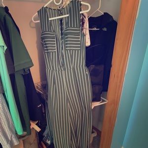Long green jumpsuit with white stripes and belt